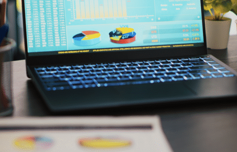 Calculator, pound coins and a laptop on a desk, illustrating AiBoost's August 2026 analysis of what Google Ads costs UK small businesses.