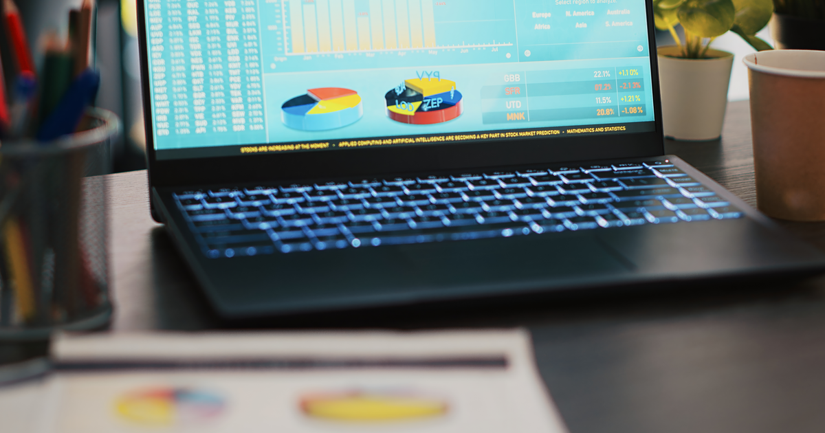 Calculator, pound coins and a laptop on a desk, illustrating AiBoost's August 2026 analysis of what Google Ads costs UK small businesses.