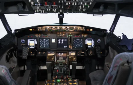 An empty aircraft cockpit showing full instrument displays, illustrating automation that still leaves the operator able to read the instruments.