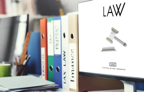 A solicitor's desk with contract papers and reference materials, illustrating AiBoost's analysis of Google Ads costs for UK law firms.