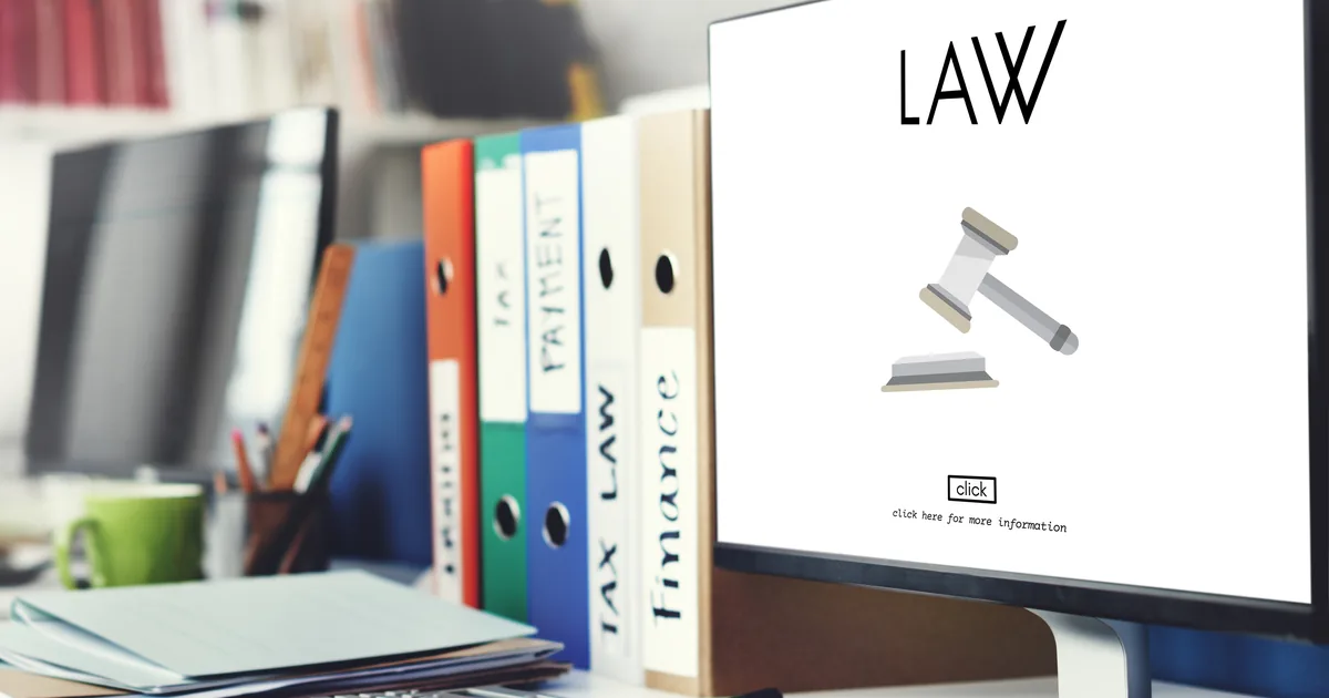 A solicitor's desk with contract papers and reference materials, illustrating AiBoost's analysis of Google Ads costs for UK law firms.
