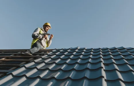 A roofer working on a pitched roof, illustrating AiBoost's analysis of what UK trades pay for advertising clicks and leads.