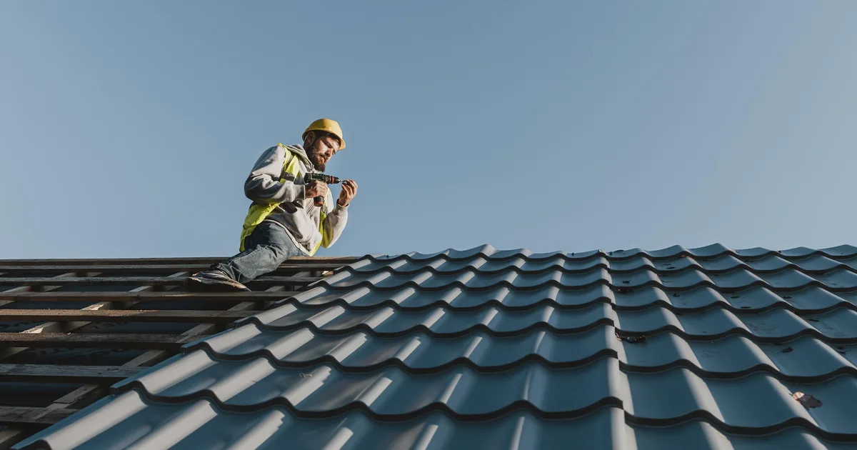 A roofer working on a pitched roof, illustrating AiBoost's analysis of what UK trades pay for advertising clicks and leads.